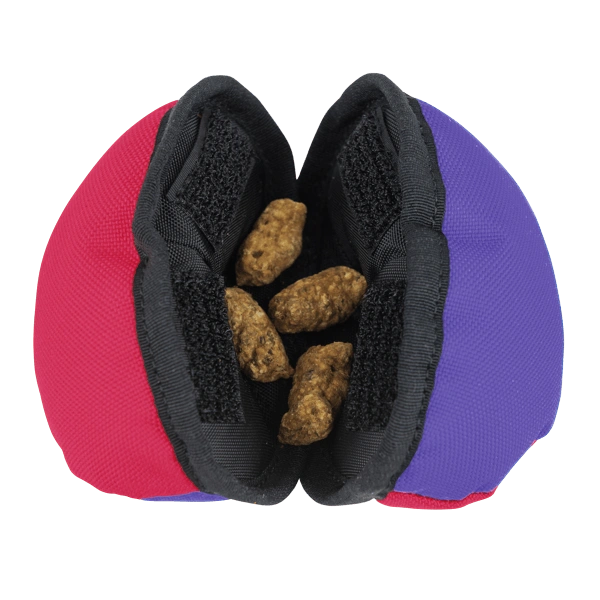 Treat dog toy showing kibble in the middle for the dog to open.  Clam is Pink & Purple